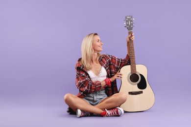 Photo of Happy hippie woman with guitar on purple background. Space for text