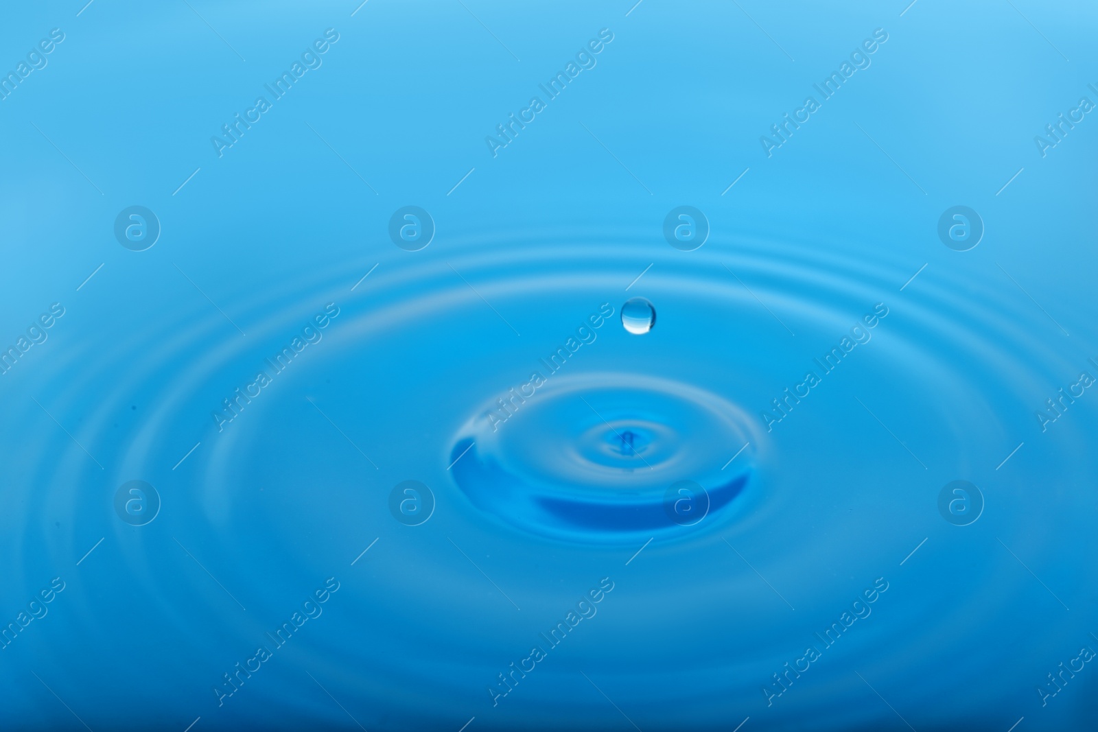 Photo of Splash of blue water with drop as background, closeup