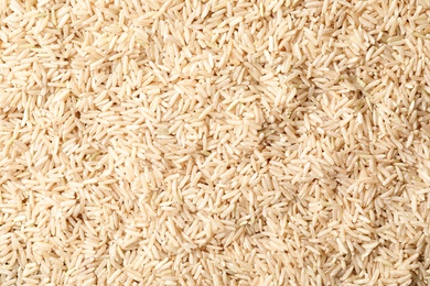 Photo of Raw brown rice as background, top view