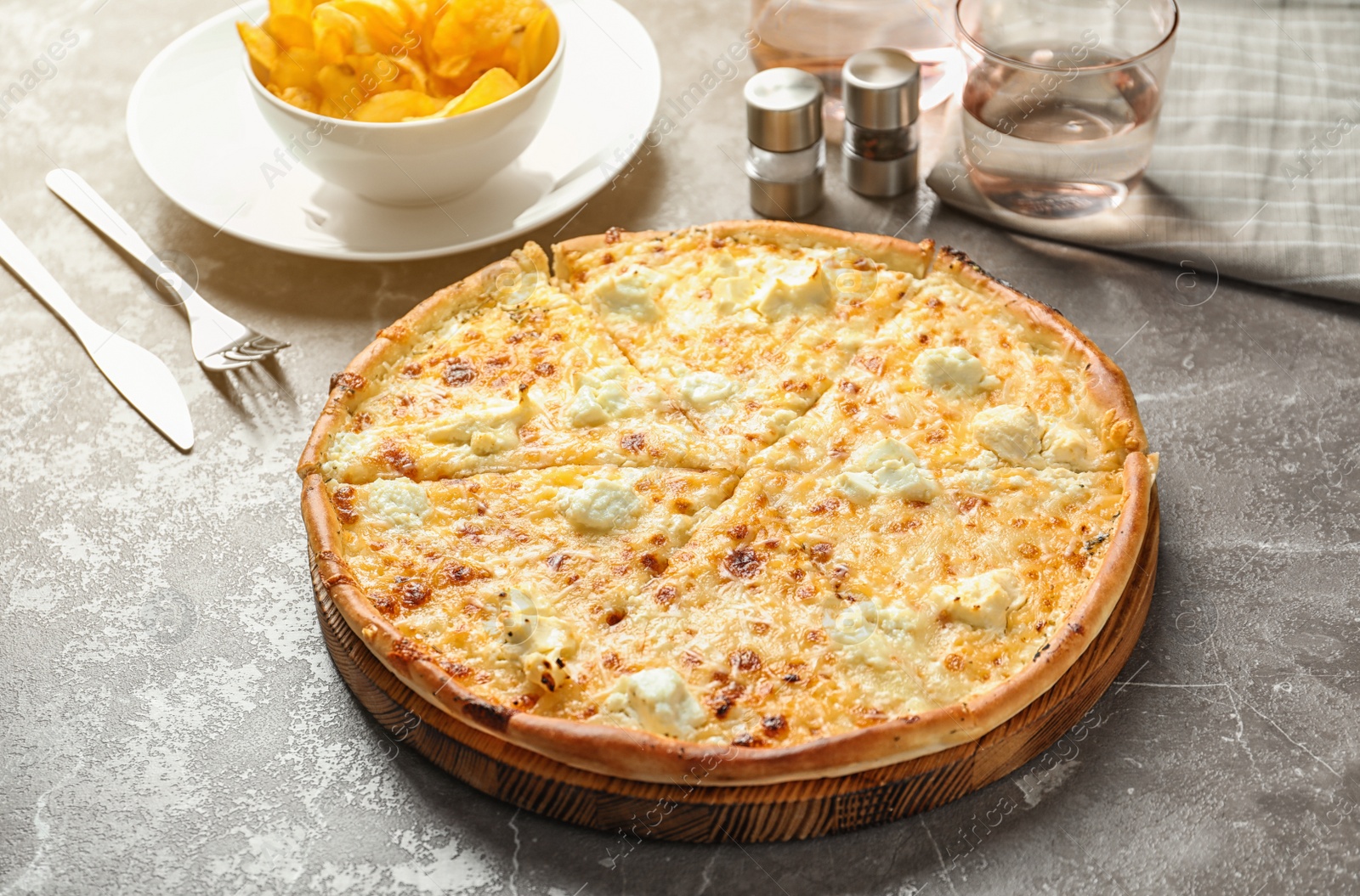 Photo of Delicious hot cheese pizza on grey table