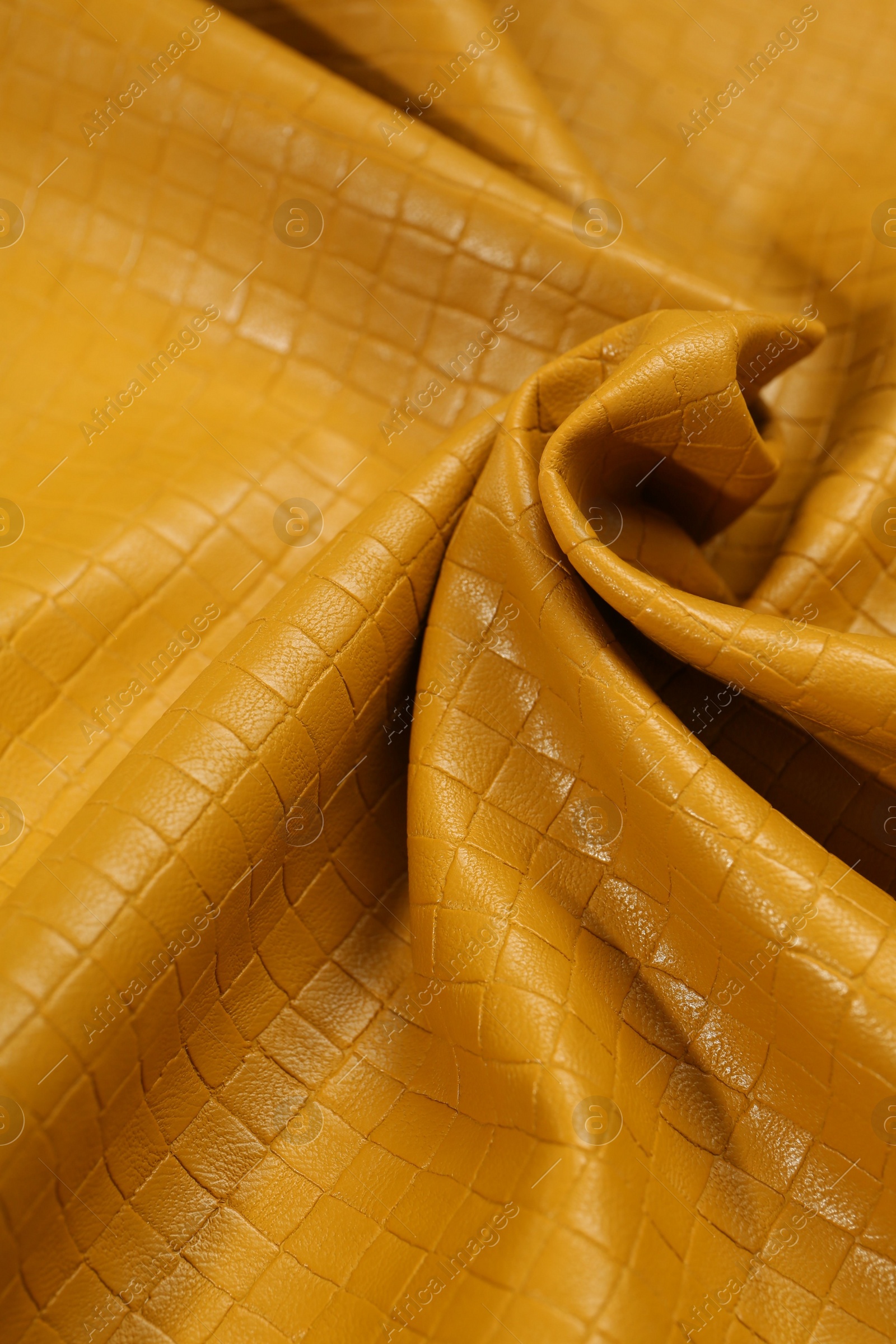 Photo of Beautiful yellow leather as background, closeup view