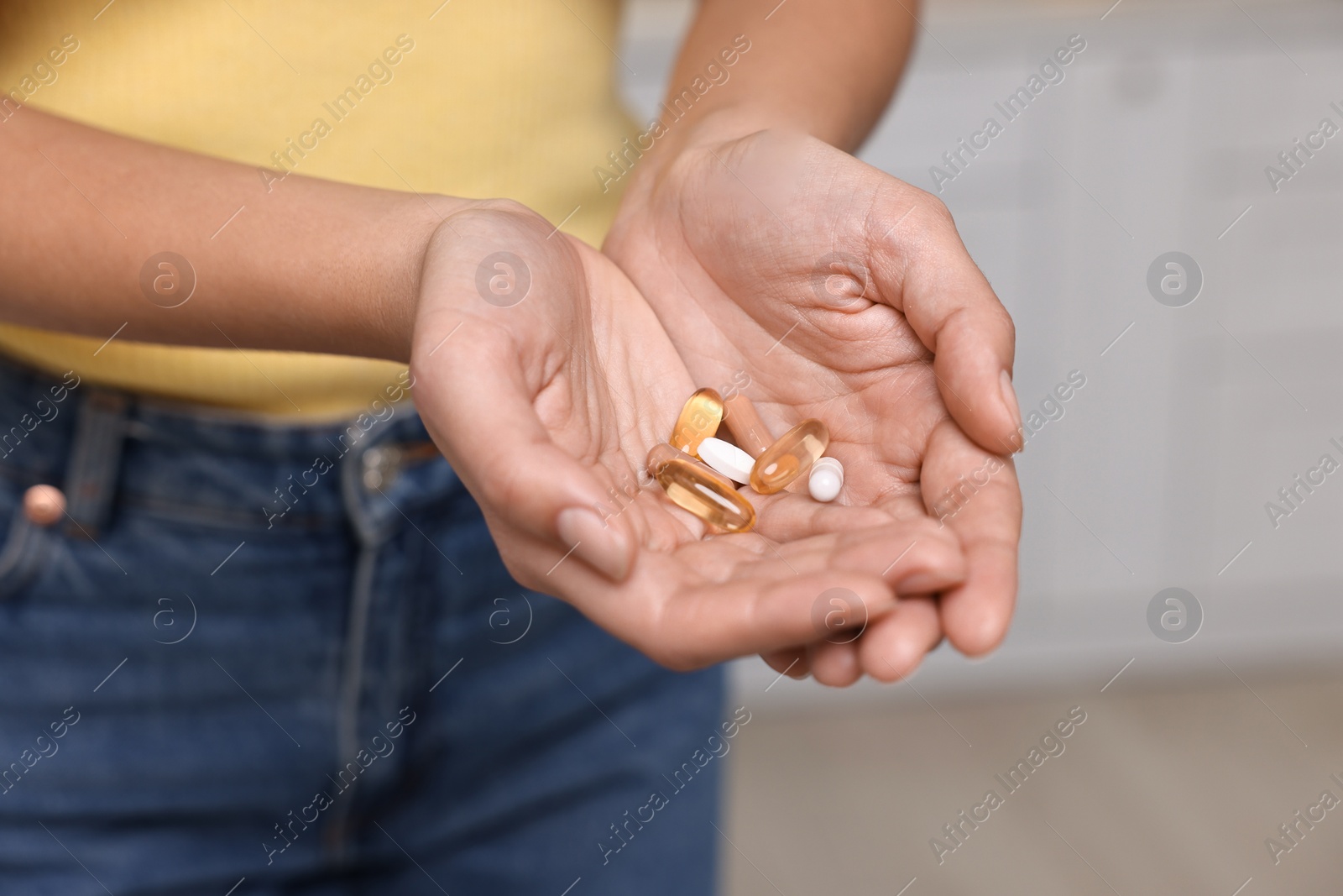 Photo of Woman with vitamin pills at home, closeup