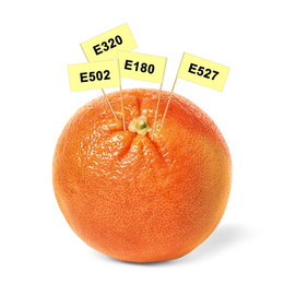 Image of Fresh orange with E numbers isolated on white. Harmful food additives 