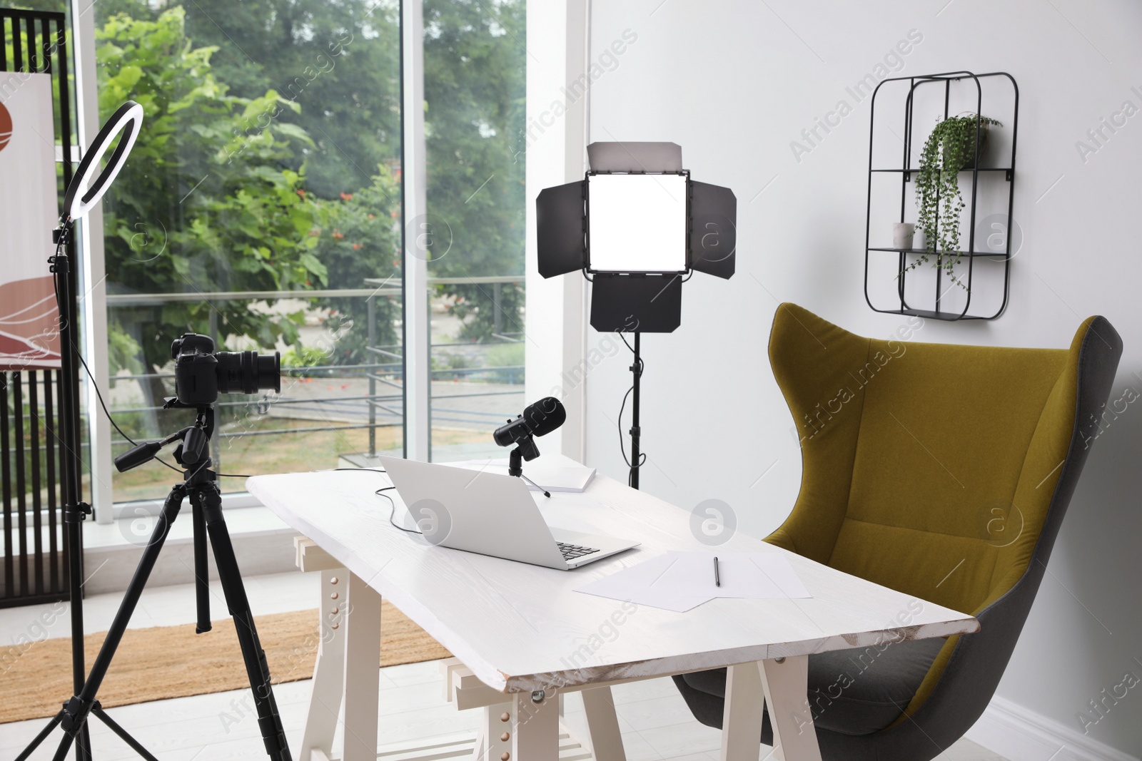 Photo of Modern blogger's workplace with professional equipment and laptop in room