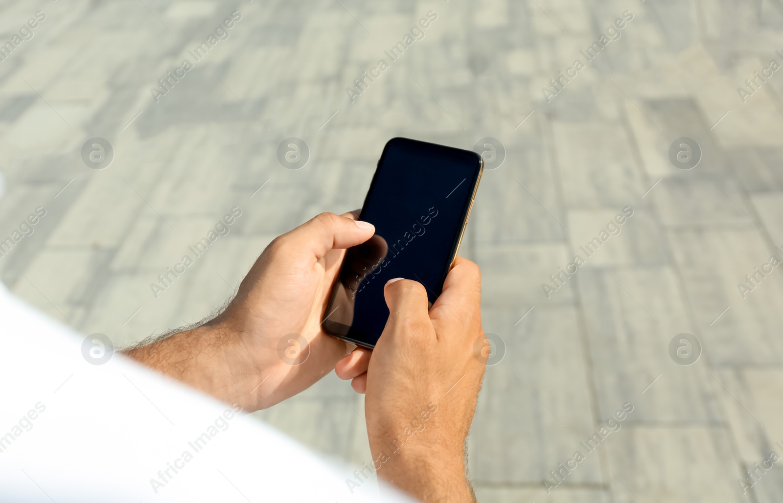 Photo of Man using modern mobile phone outdoors, closeup