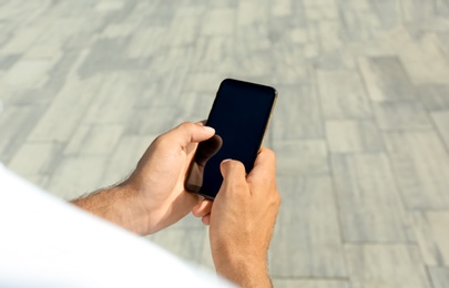 Man using modern mobile phone outdoors, closeup