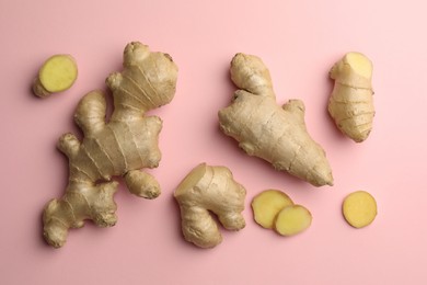 Fresh ginger on pale pink background, flat lay