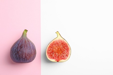 Photo of Fresh ripe figs on color background, top view. Space for text