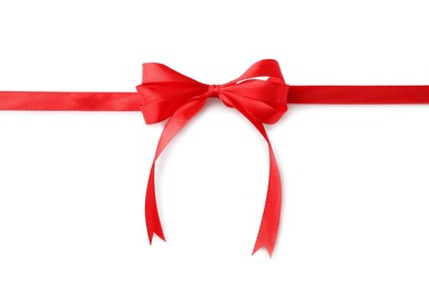 Red bow and ribbon on white background, top view