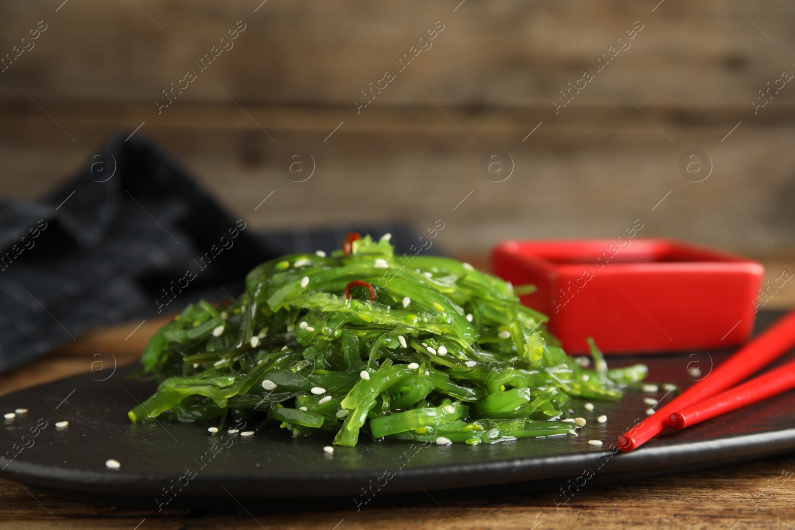 Photo of Japanese seaweed salad served on table, closeup