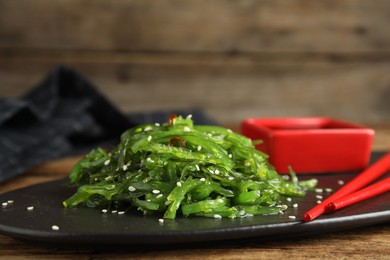 Photo of Japanese seaweed salad served on table, closeup