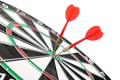 Photo of Dart board with color arrows hitting target, closeup