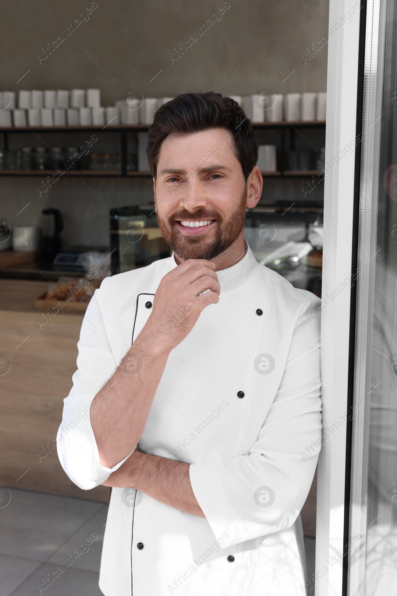 Photo of Portrait of professional baker in bakery shop