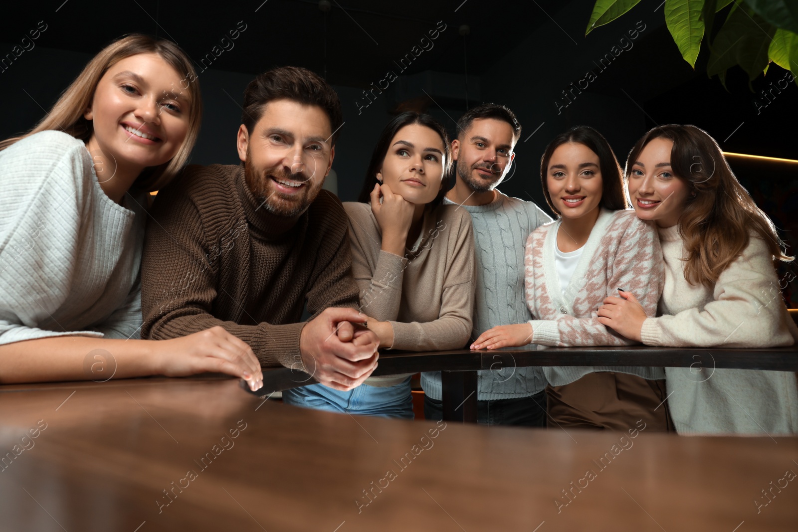 Photo of Group of friends spending time together in cafe