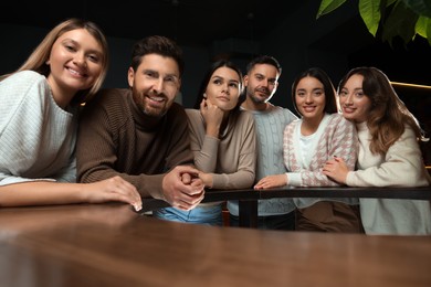 Photo of Group of friends spending time together in cafe