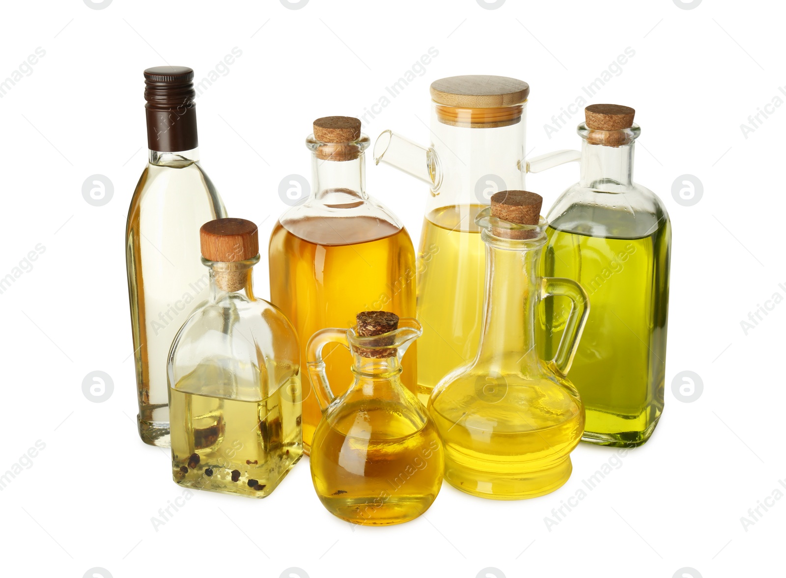 Photo of Vegetable fats. Glassware of different cooking oils isolated on white