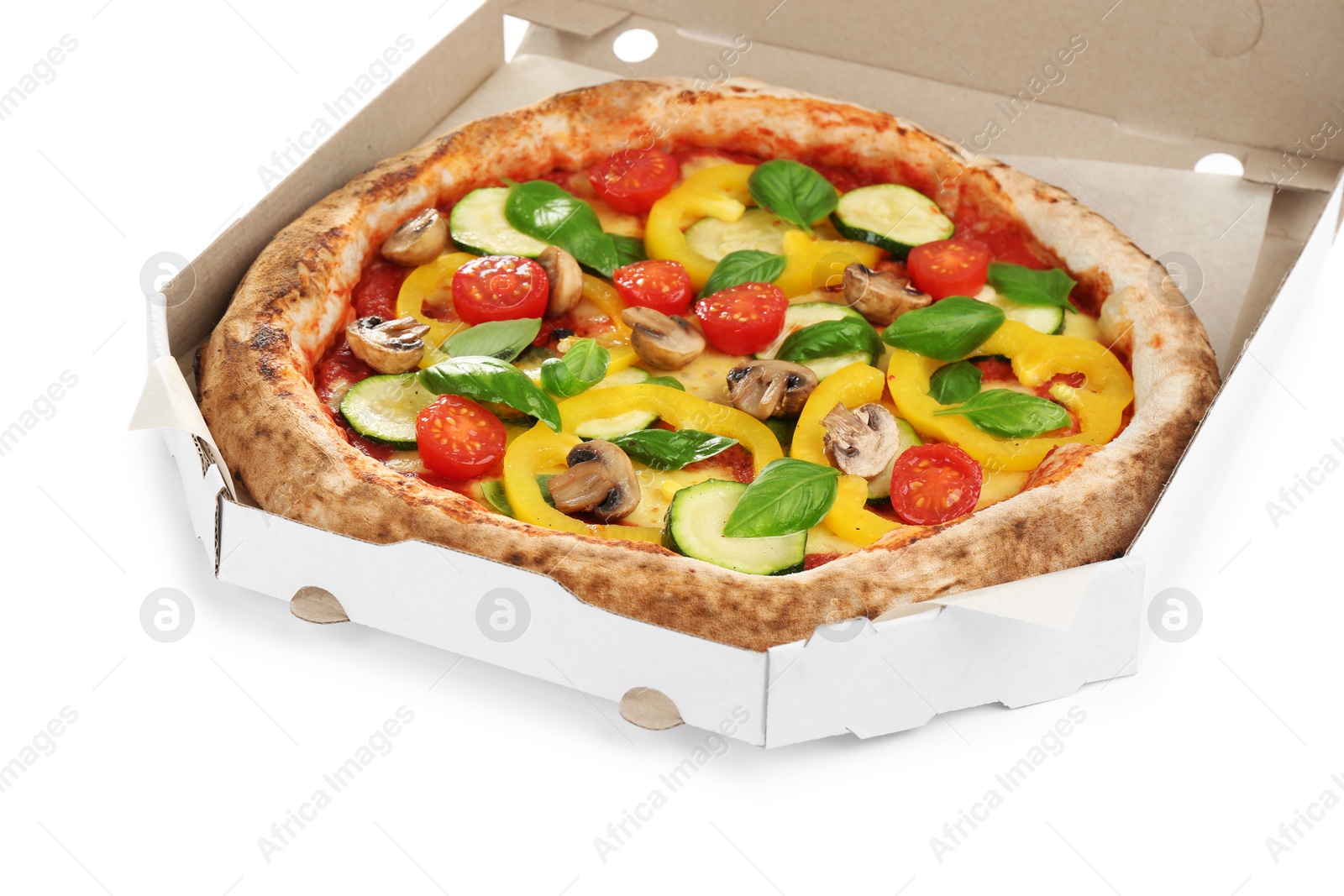 Photo of Delicious vegetable pizza in cardboard box on white background, closeup