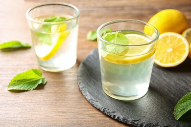 Glass with lemon water on slate plate