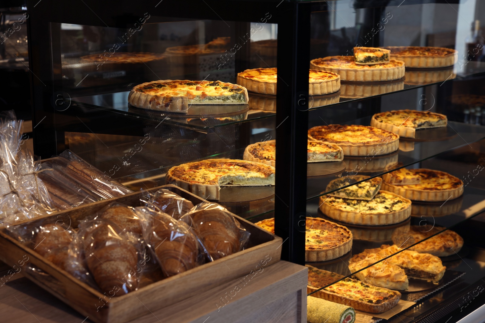 Photo of Counter with different tasty pastries in bakery shop