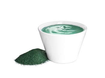 Photo of Freshly made spirulina facial mask in bowl and powder on white background