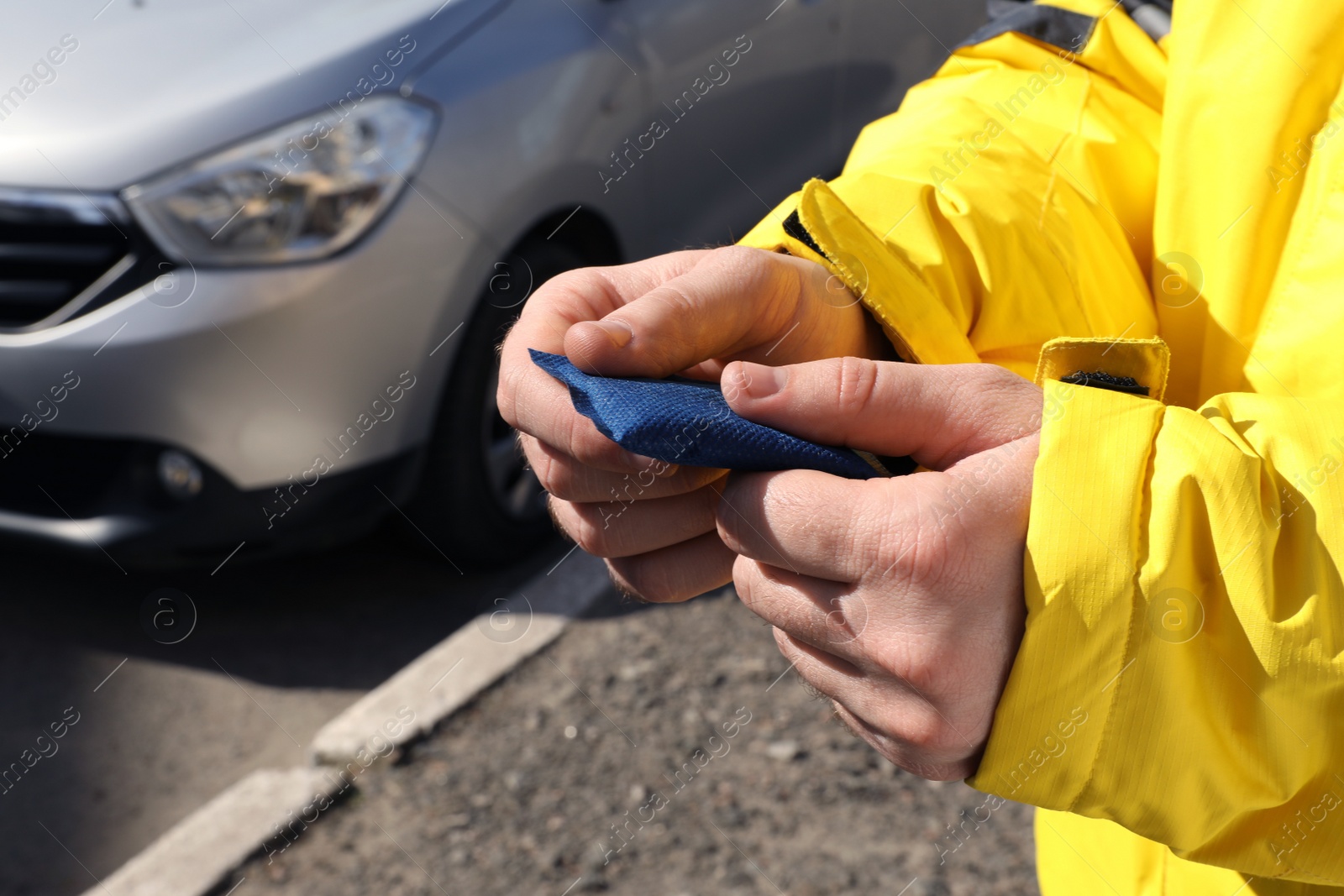 Photo of Man holding hand warmer on street, closeup