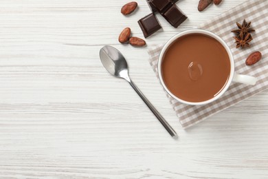 Flat lay composition with yummy hot chocolate on white wooden table. Space for text