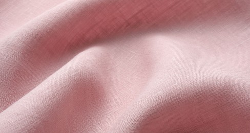 Texture of pink crumpled fabric as background, closeup