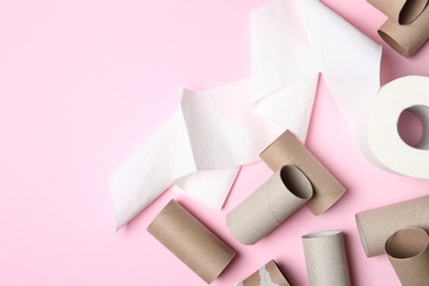 Flat lay composition with toilet paper and empty rolls on color background. Space for text