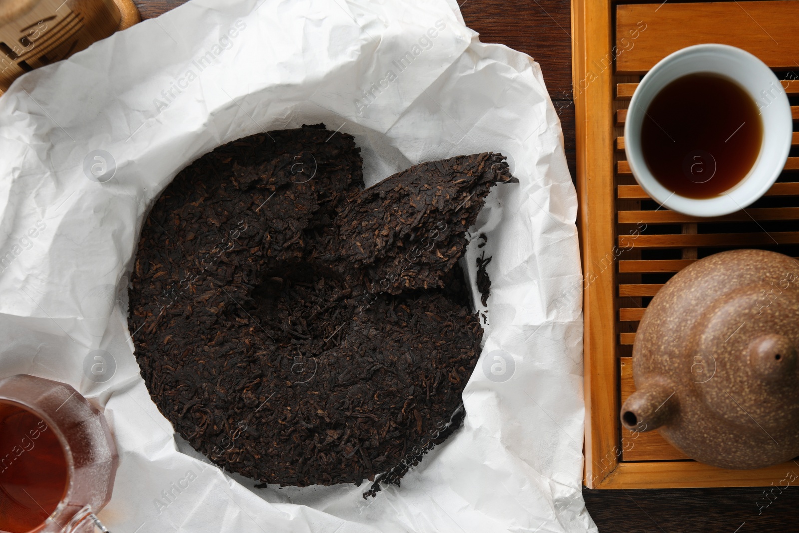 Photo of Flat lay composition with pu-erh tea on wooden table