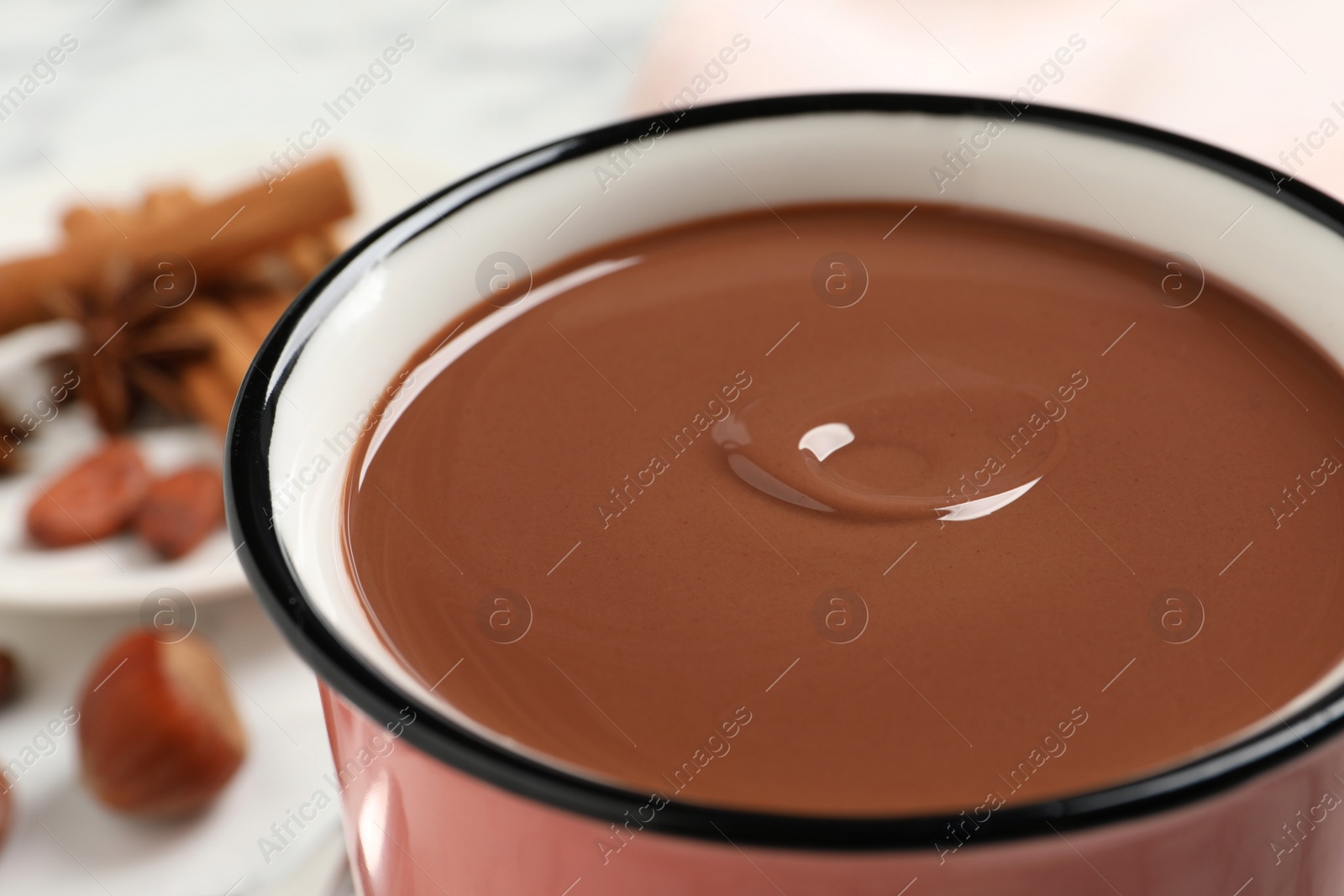 Photo of Yummy hot chocolate in mug on table, closeup
