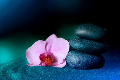 Image of Spa stones and orchid flower on sand with beautiful pattern. Zen concept