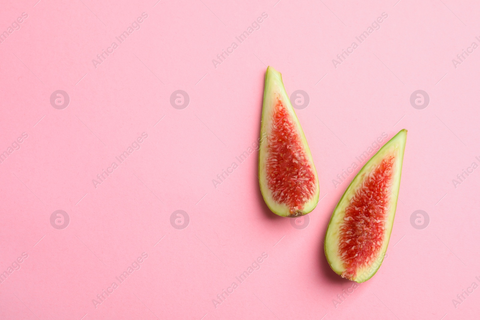 Photo of Fresh ripe fig slices on color background, top view. Space for text