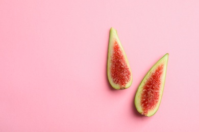 Photo of Fresh ripe fig slices on color background, top view. Space for text