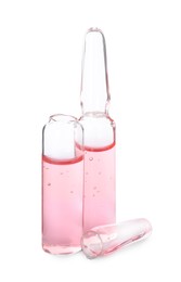 Photo of Open and closed glass ampoules with pharmaceutical product on white background