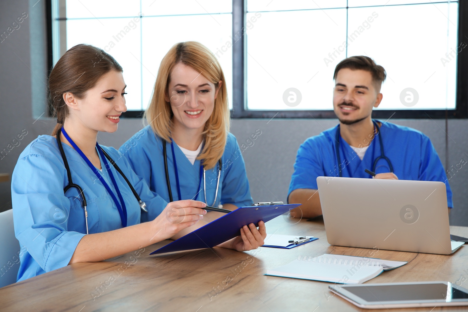 Photo of Medical students in uniforms studying at university