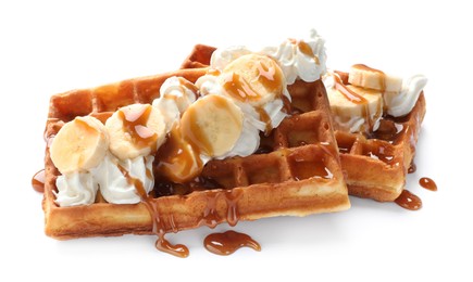 Photo of Delicious Belgian waffles with banana, whipped cream and caramel sauce isolated on white
