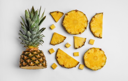 Composition with raw cut pineapple on white background, top view