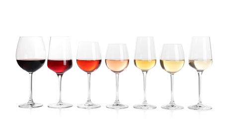 Photo of Row of glasses with different wines on white background