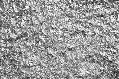 Photo of Crumpled silver foil as background, closeup view