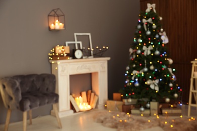 Photo of Blurred stylish room interior with Christmas tree and decorative fireplace