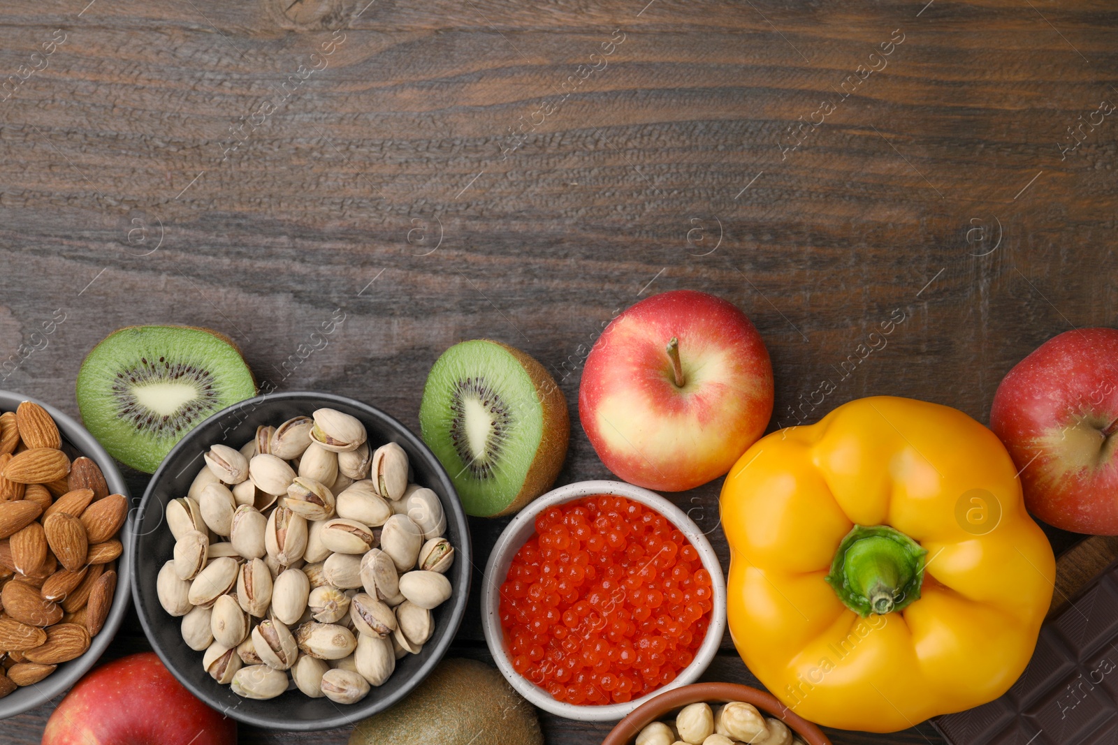 Photo of Many different products on wooden table, flat lay and space for text. Natural sources of serotonin