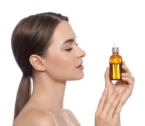 Photo of Young woman with bottle of essential oil on white background