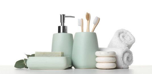 Photo of Bath accessories. Different personal care products and eucalyptus branch on table against white background