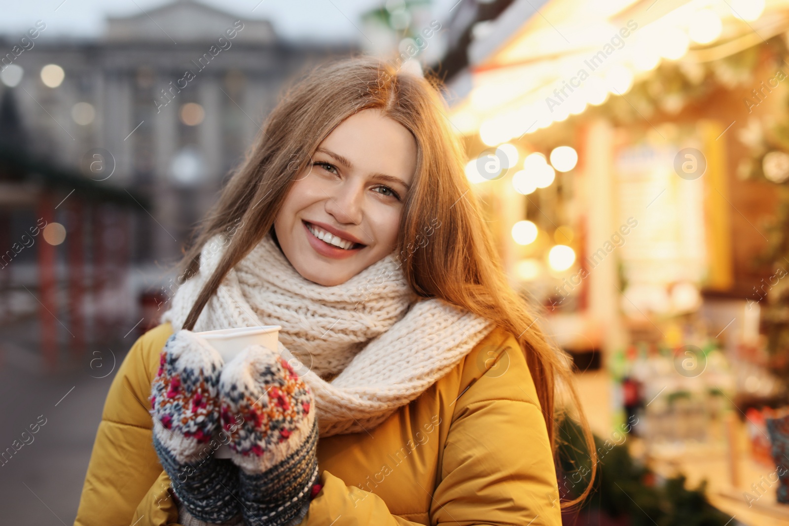 Photo of Happy woman with mulled wine at winter fair