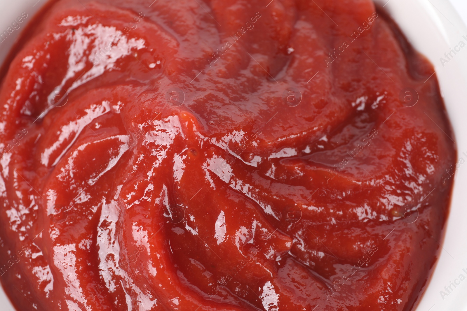 Photo of Organic ketchup in bowl, closeup. Tomato sauce