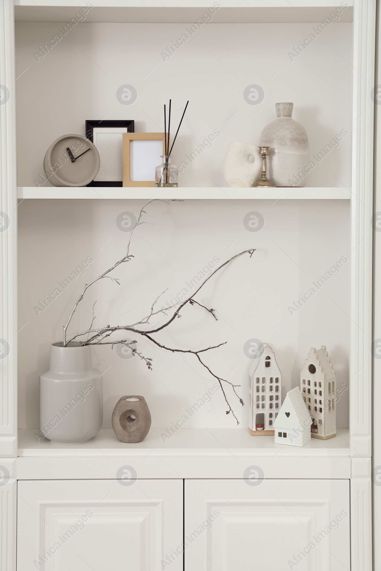 Photo of Stylish shelves with different decor elements in room. Interior design