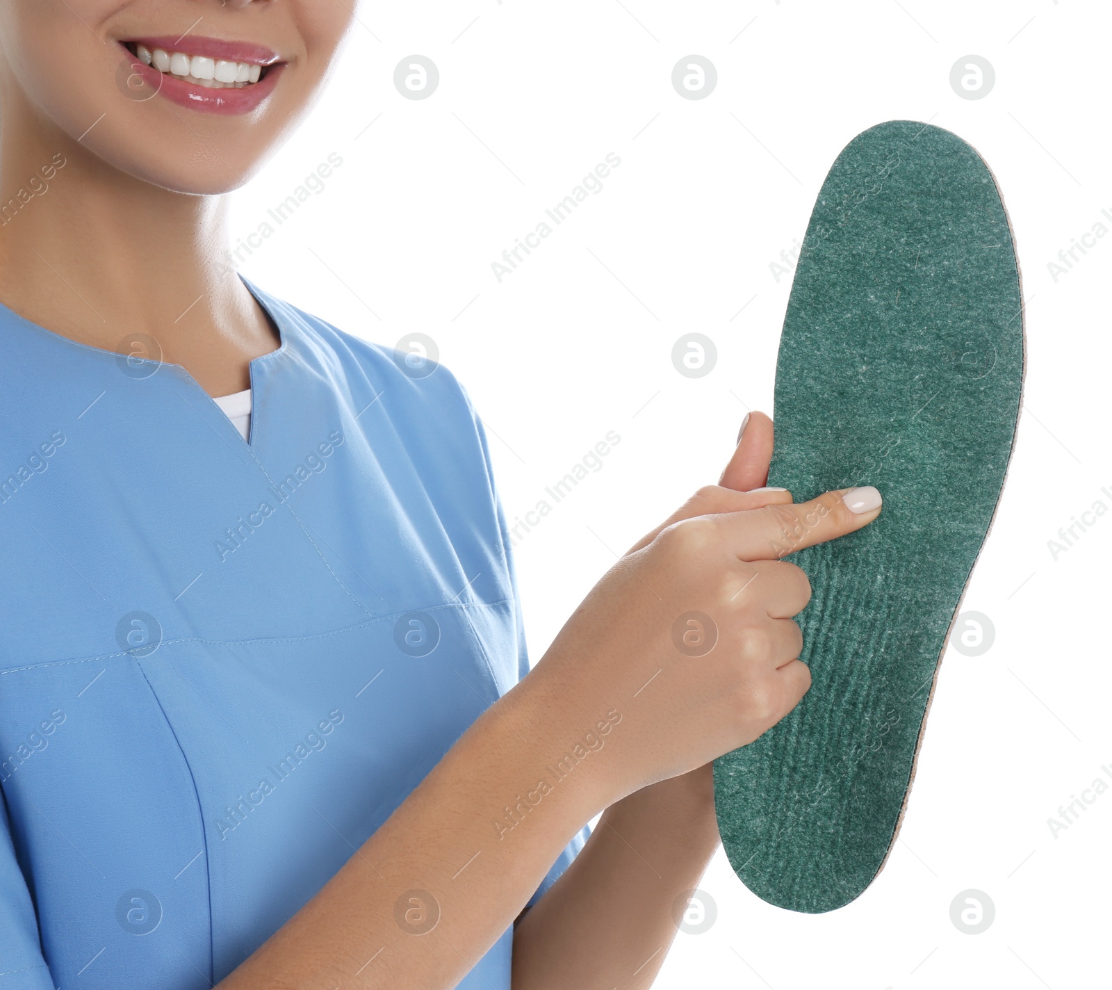 Photo of Female orthopedist showing insole on white background, closeup