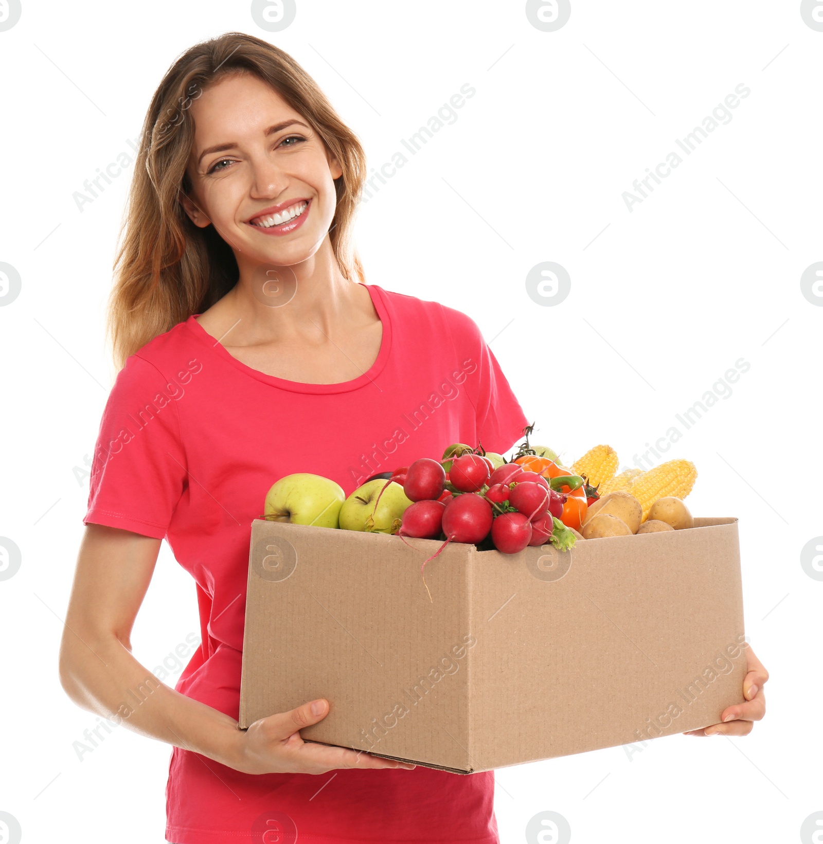 Photo of Young woman with box of fresh vegetables on white background