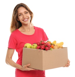 Young woman with box of fresh vegetables on white background