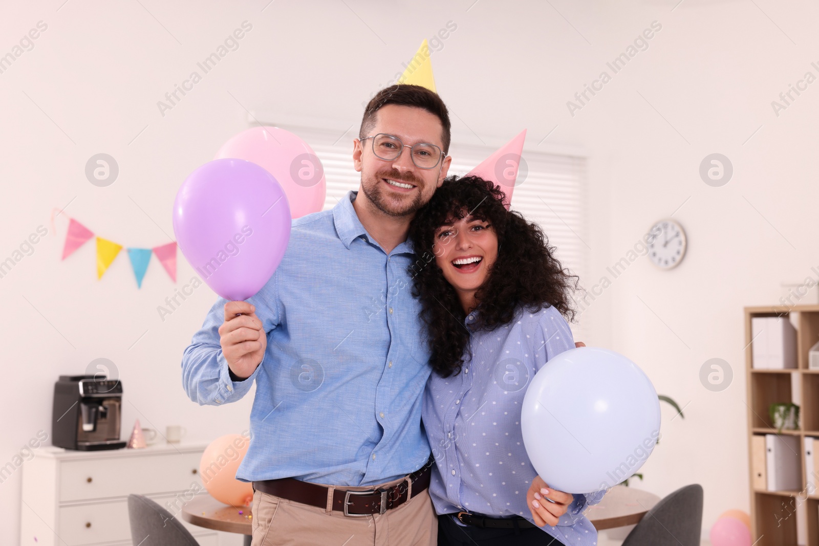 Photo of Coworkers having fun during office party indoors